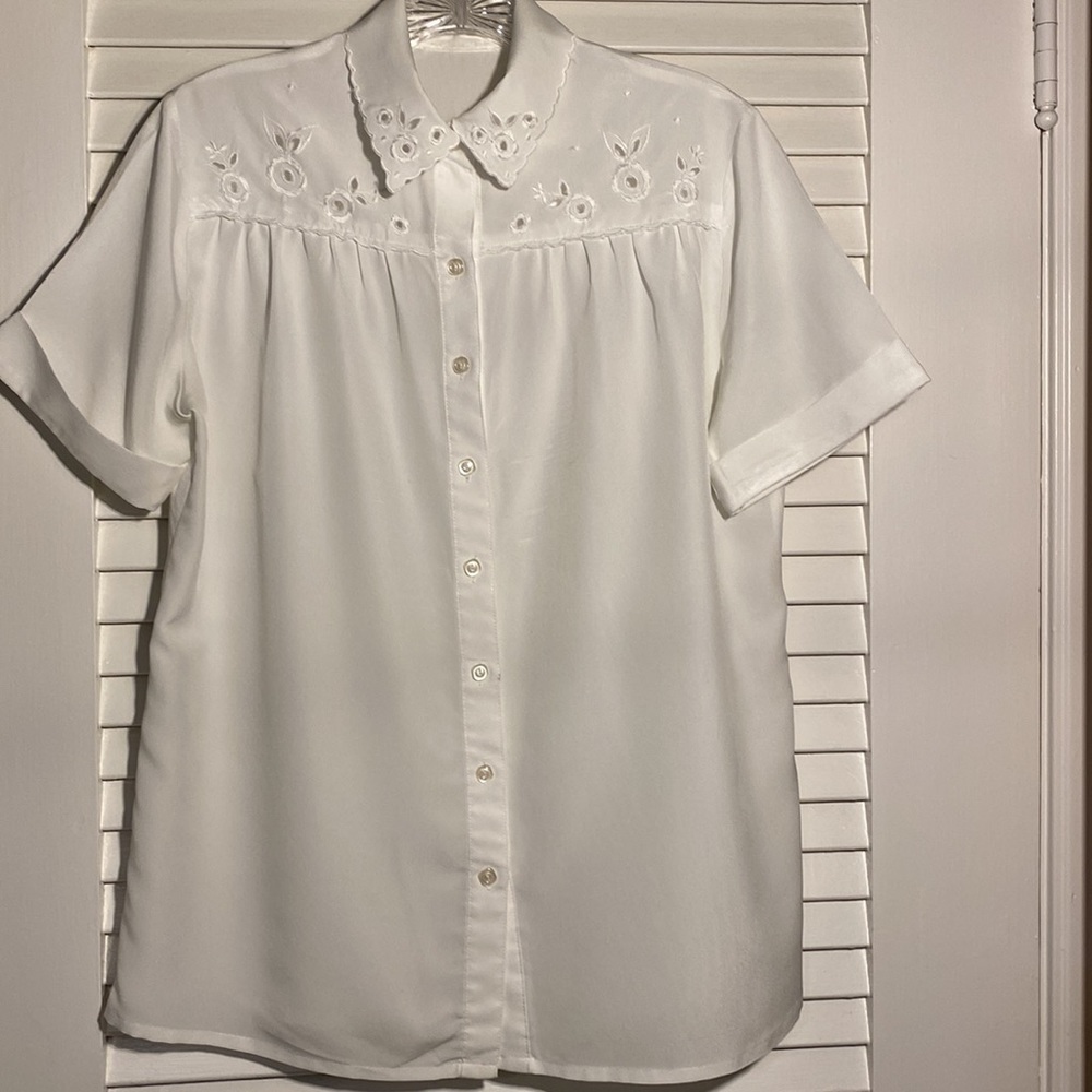 White eyelet collar/front, short sleeves, gathered back, 100% polyester.